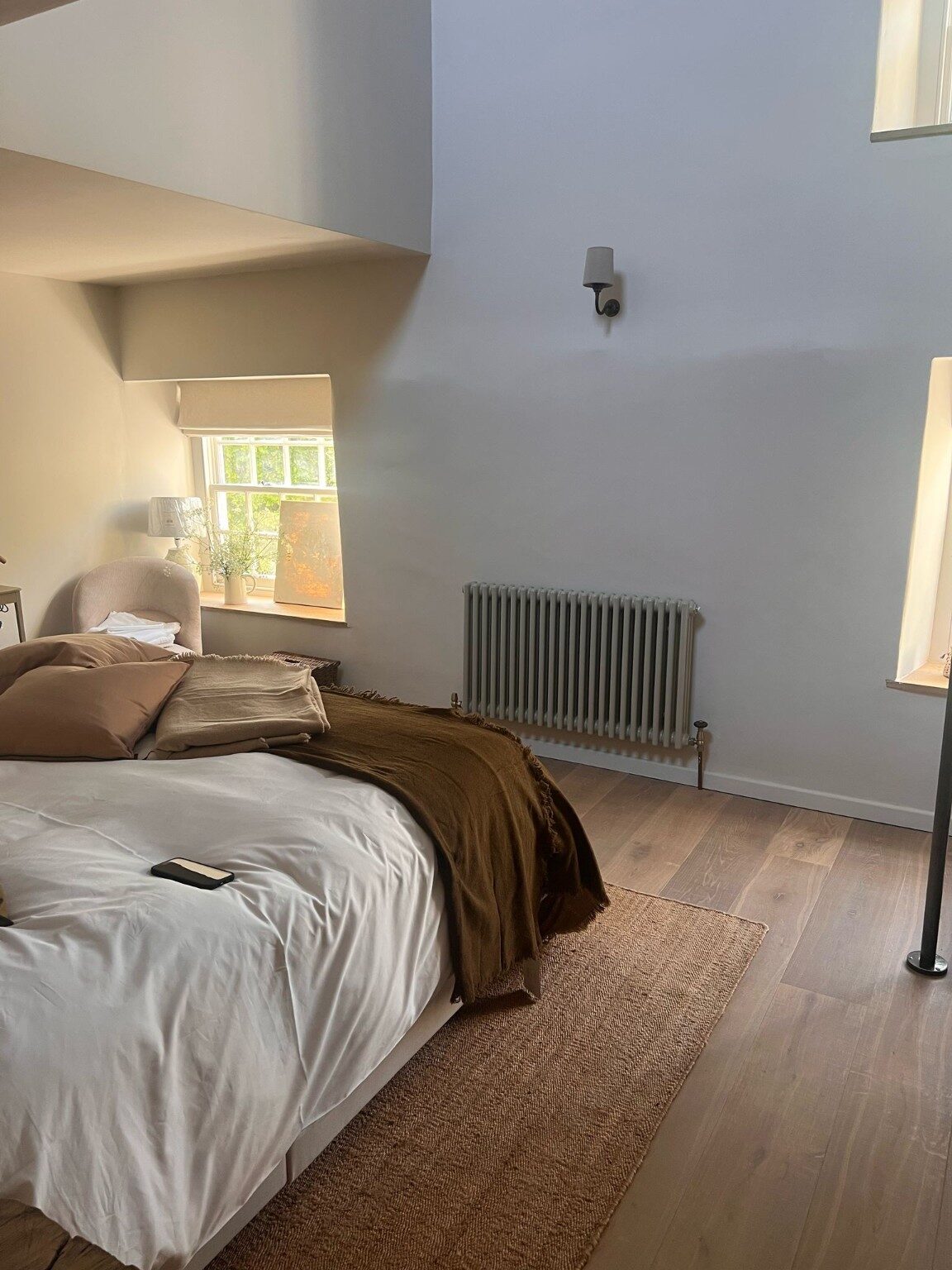 Completed bedroom renovation with timber floor and tall ceiling