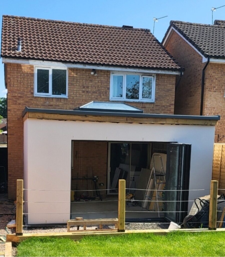 Rendered single-storey rear extension with dark framed bifold doors